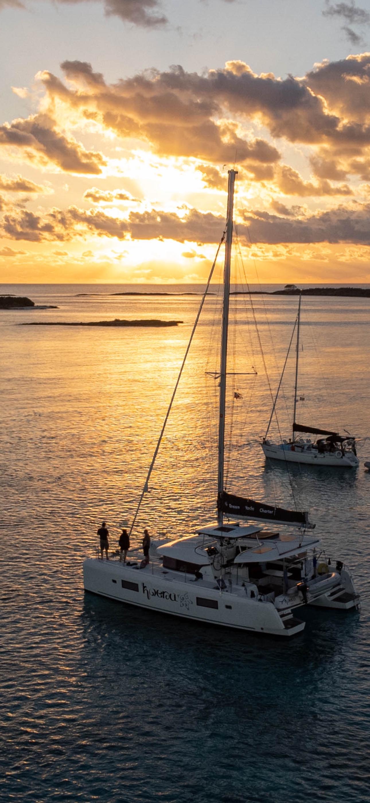 sailing yacht on open ocean at sunset, dramatic sky with golden light, professional sailing photography, cinematic quality, wide angle